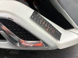 a close up of a car ' s grille with a sticker on it