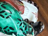 a figurine of a frog sitting on a table