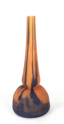 a blue and orange vase sitting on a white surface