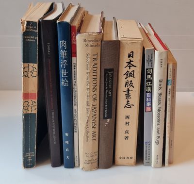 a lot of books that are stacked up on a table