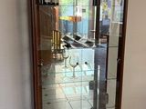 a glass display case with bottles of wine in it