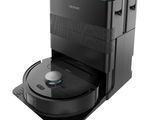 the robot vacuum is on top of a black box