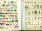 an open book with stamps on the pages and a picture of a man ' s face on the pages