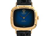 a close up of a wrist watch with a blue face