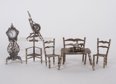 four chairs and a table with a clock on it