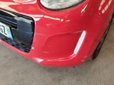 a red car that is parked in a garage