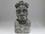 a close up of a stone statue of a man with a crown on his head