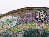 a close up of a decorative plate with flowers and birds on it