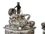 pair of antique silver plated figurines of a man and a woman on a boat