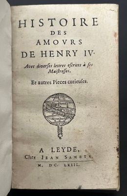 an old book sitting on top of a table next to a white cloth