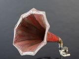 a red and silver gramphone sitting on a black table