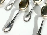 many spoons that are lined up together on a table