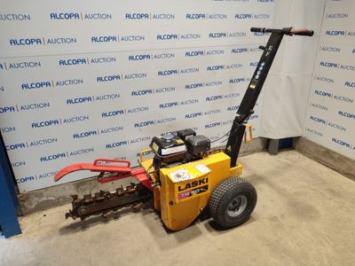 an image of a small machine that is parked in front of a wall