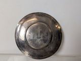 a silver plate sitting on top of a white counter