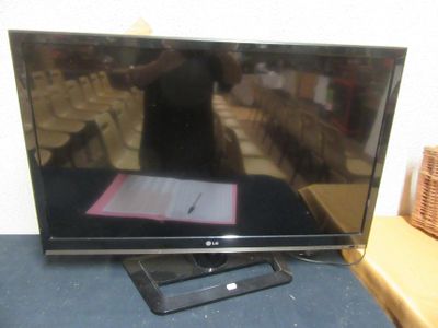 a flat screen tv sitting on a table in a room