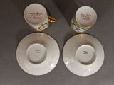 two cups and saucers are sitting on a table