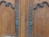 a large wooden door with a metal handle on it
