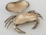 a silver crab with a shell in its shell