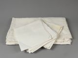 a stack of four white napkins sitting on top of each other