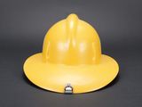 a close up of a yellow hard hat on a black background
