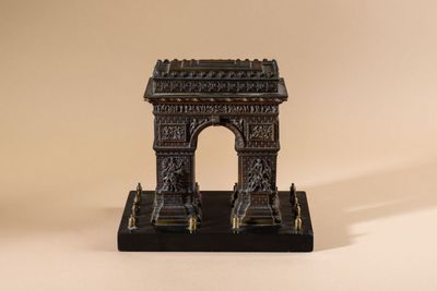 an image of a small statue of a building on a table