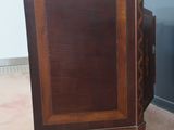 a small wooden cabinet with a door on top of it