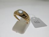 a close up of a gold ring with a stone on it