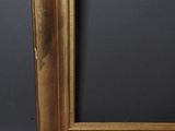 an antique gold frame with a black background