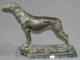 statue en bronze représentant un chien, posée sur un socle en marbre, sur fond gris
