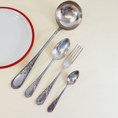 a plate, spoons, and a bowl on the table