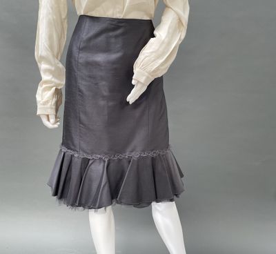 an image of a mannequin wearing a black skirt and white shirt