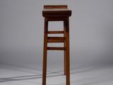 an image of a wooden stool sitting on top of a white floor