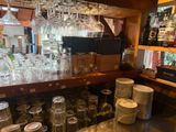 a bar with a lot of wine glasses on it
