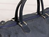 a close up of a blue bag with a zipper
