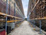 rows of pallets in a warehouse filled with lots of wood