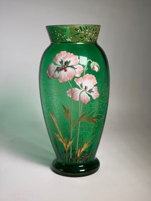 a green vase with pink flowers painted on it