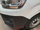 a white van parked in a parking lot next to a red curb