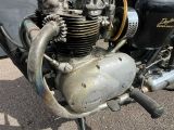 a close up of a motorcycle engine on the ground