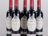 four bottles of wine are lined up on a table