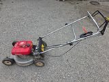 a small lawn mower that is sitting on the ground