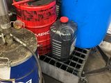a blue barrel sitting next to two red barrels