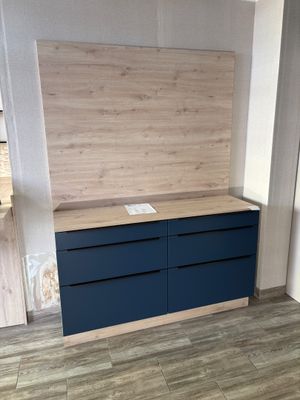 an image of a room with a wooden wall and a blue dresser