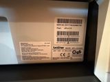 a label on the back of a box that says brother