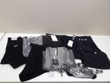 several pairs of men ' s pants on a white table