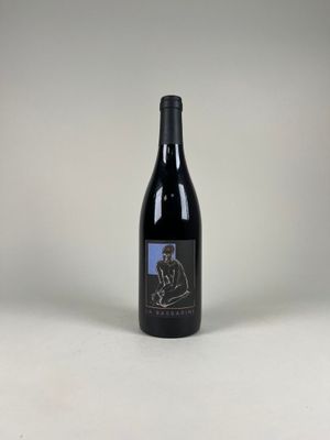 the bottle of wine is sitting on the table with the label on it