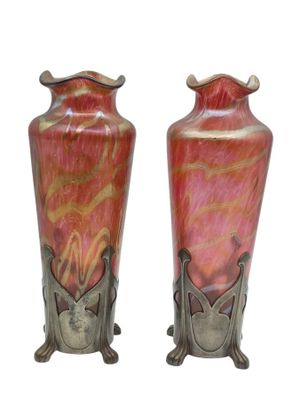 two vases that are sitting side by side on a white background