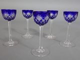 six wine glasses with blue and white designs are lined up on a table