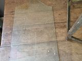 a piece of metal sitting on a table next to a chair