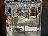 a mirror that is sitting on a table next to a vase