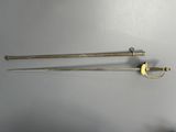 pair of antique swords with brass fittings on a white background